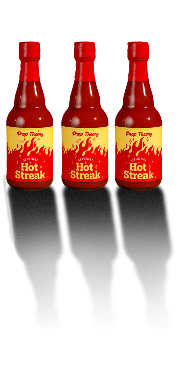 Three bottles of Drop Theory “Original Hot Streak” hot sauce displayed in a row against a pink tiled background.